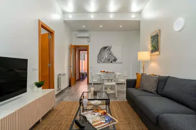 a living room with a couch and a table at AB North Barcelona Apartments in Santa Coloma