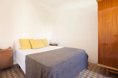 a bedroom with a bed with two pillows on it at Sagrada Familia V by Enjoy Apartments in Barcelona