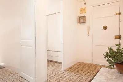 a hallway with a white door and a potted plant at Sagrada Familia V by Enjoy Apartments in Barcelona