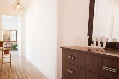a living room with a dresser and a mirror at Sagrada Familia V by Enjoy Apartments in Barcelona