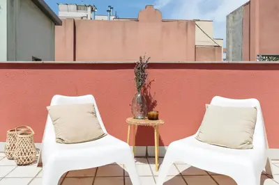 two white chairs and a table on a roof at Enjoy Apartments Maria II in Barcelona