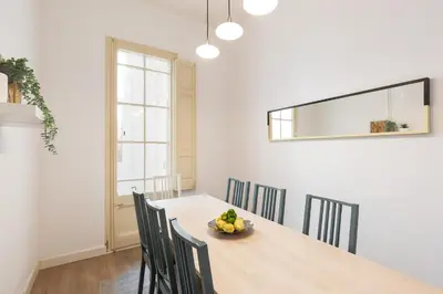 a dining room table with chairs and a bowl of fruit at Sagrada Familia II by Enjoy Apartments in Barcelona