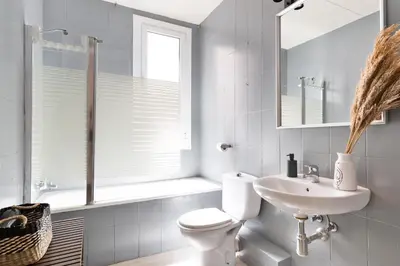 a bathroom with a toilet and a sink and a window at Sagrada Familia III by Enjoy Apartments in Barcelona