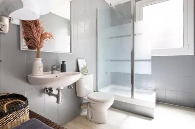 a bathroom with a toilet and a sink and a shower at Sagrada Familia III by Enjoy Apartments in Barcelona