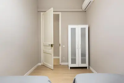 an empty room with two beds and an open door at Sagrada Familia I by Enjoy Apartments in Barcelona