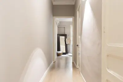 a hallway with white walls and an open door at Sagrada Familia I by Enjoy Apartments in Barcelona