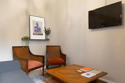 a living room with a table and chairs and a flat screen tv at Sagrada Familia I by Enjoy Apartments in Barcelona