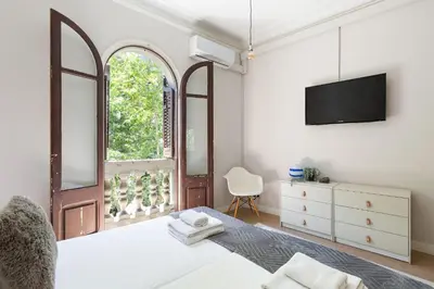 a bedroom with a bed and a tv on a wall at Sagrada Familia IV by Enjoy Apartments in Barcelona