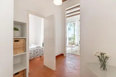 a white room with a mirror and a table at Vistamar 1: Primera línea de mar con encanto in Sitges