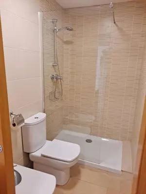 a bathroom with a toilet and a shower and a sink at Precioso loft al lado Parc Vallparadís by Lofties in Terrassa