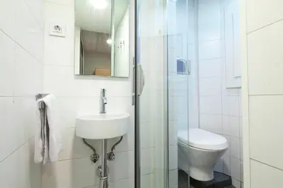 a bathroom with a toilet and a sink and a shower at Putxet by gaiarooms in Barcelona