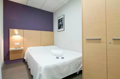 a room with a large bed in a room at Putxet by gaiarooms in Barcelona