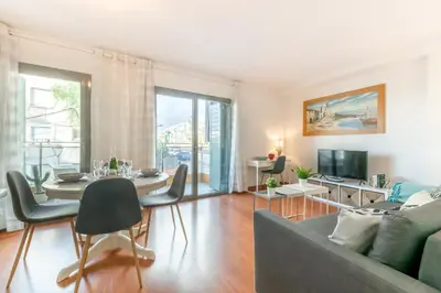 a living room with a couch and a table at Sant Sebastià Moderno apartamento a 100 metros de la playa in Sitges