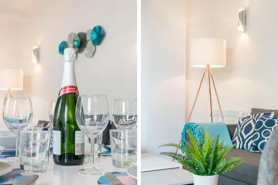 a bottle of wine sitting on a table with glasses at Sant Sebastià Moderno apartamento a 100 metros de la playa in Sitges