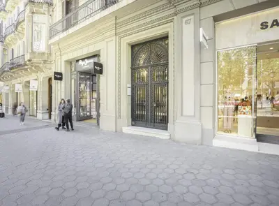 a group of people walking down a street in front of a store at SibsBcn-Paseo de Gracia Penthouse-Luxury-Terraces in Barcelona