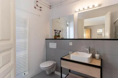 a bathroom with a sink and a toilet and a mirror at SibsBcn-Paseo de Gracia Penthouse-Luxury-Terraces in Barcelona