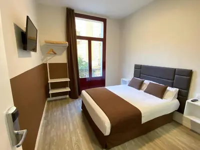 a bedroom with a large bed and a window at BCN Urbaness Hotels Bonavista in Barcelona