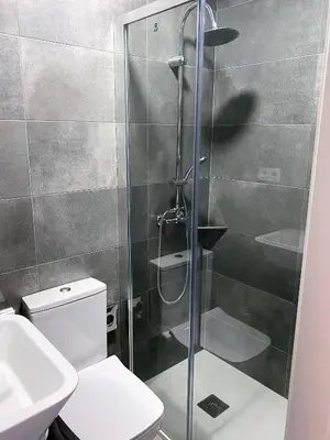 a bathroom with a shower with a toilet and a sink at BCN Urbaness Hotels Bonavista in Barcelona