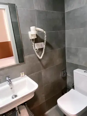 a bathroom with a sink and a phone on the wall at BCN Urbaness Hotels Bonavista in Barcelona