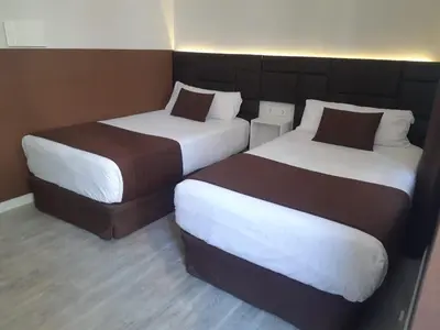 two beds sitting next to each other in a room at BCN Urbaness Hotels Bonavista in Barcelona