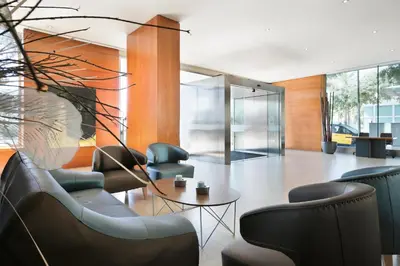 a lobby with chairs and a table in a building at Hotel Best Front Maritim in Barcelona