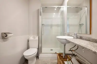 a bathroom with a shower and a toilet and a sink at Apartments Sata Sagrada Familia Area in Barcelona