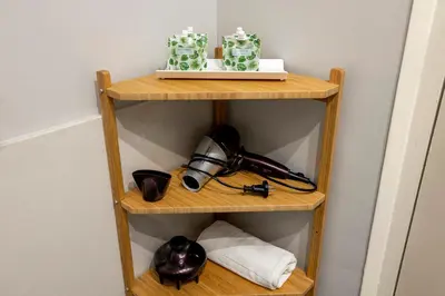 a shelf in a room with a telephone and flowers at Apartments Sata Sagrada Familia Area in Barcelona