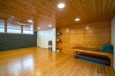 a large room with a wooden wall and a bench in it at Hotel Somlom - ECO Friendly Montseny in Sant Esteve de Palautordera
