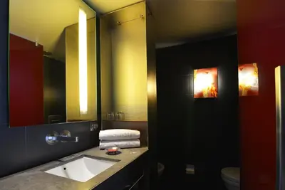 a bedroom with a bed and a desk and a television at Hotel Soho in Barcelona