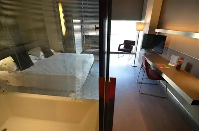 a bathroom with a tub and a sink and a mirror at Hotel Soho in Barcelona