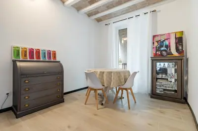 a dining room with a table and chairs and a dresser at Hauzify I Novavila Centre Rooms in Vilanova i la Geltrú