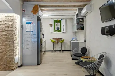 a hallway with chairs and a table in a room at Hauzify I Novavila Centre Rooms in Vilanova i la Geltrú