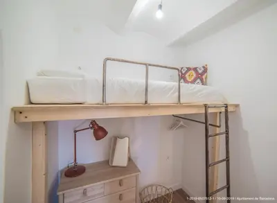 a bunk bed in a room with a desk at Welcomy Poblenou in Barcelona
