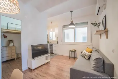 a living room with a couch and a flat screen tv at Welcomy Poblenou in Barcelona