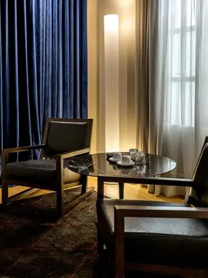 a living room with a table and two chairs at Mercer House Bòria BCN in Barcelona