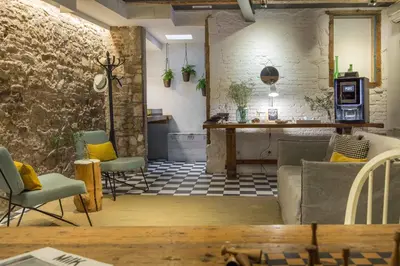 a living room with a table and chairs at Eco Boutique Hostal Grau in Barcelona