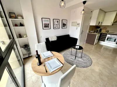 a living room with a table and a couch at Acogedor apartamento entero in Terrassa