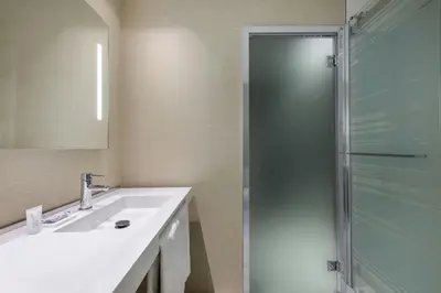 a bathroom with a sink and a shower at AC Hotel San Cugat by Marriott in Sant Cugat del Vallès