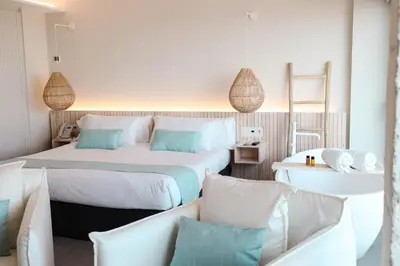 a hotel room with two beds and pillows at KAKTUS Hotel Kaktus Playa in Calella