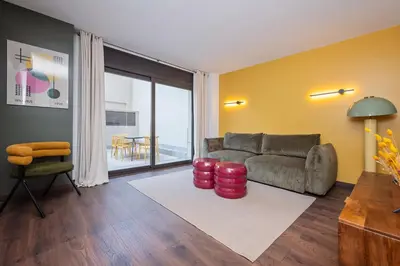 a living room with a couch and a table at Sweett - Casa Bailen in Barcelona