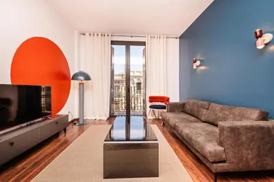 a living room with a couch and a tv at Sweett - Casa Bailen in Barcelona