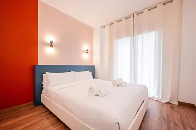 a bedroom with a white bed with two towels on it at Sweett - Casa Bailen in Barcelona