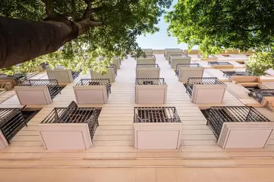 a row of benches on the side of a building at Sweett - Casa Bailen in Barcelona
