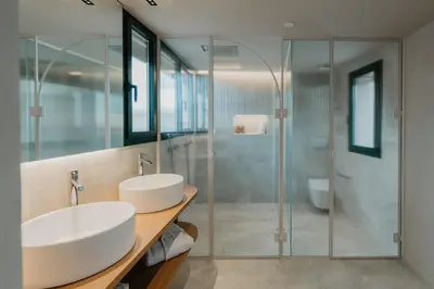 a bathroom with two sinks and a shower at Hotel Petit Luxe in Terrassa