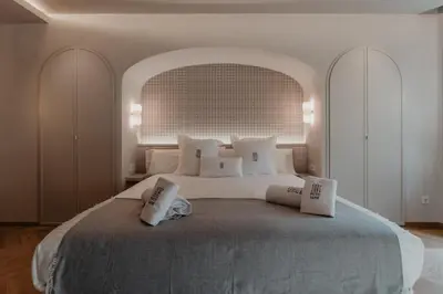 a bedroom with a large bed with two pillows on it at Hotel Petit Luxe in Terrassa