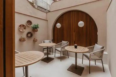 a room with two tables and chairs and a door at Hotel Petit Luxe in Terrassa