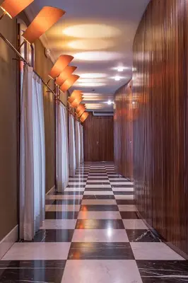 a hallway with a checkered floor in a building at Fonda Hotel 1771 in Granollers