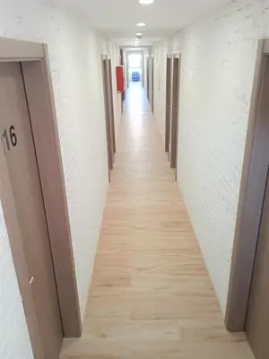 a hallway of an office building with a long corridor at Hotel 153 in Castelldefels