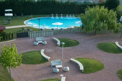 an aerial view of a swimming pool with chairs and tables at BAH Barcelona Airport Hotel in El Prat de Llobregat