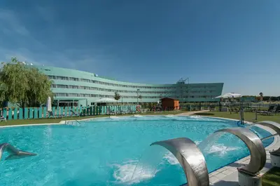 a large swimming pool in front of a building at BAH Barcelona Airport Hotel in El Prat de Llobregat